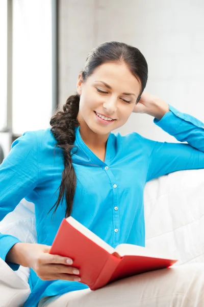 Happy and smiling woman with book — Stock Photo, Image