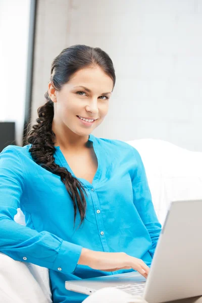 Happy woman with laptop computer Stock Picture