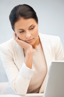 Pensive woman with laptop computer clipart