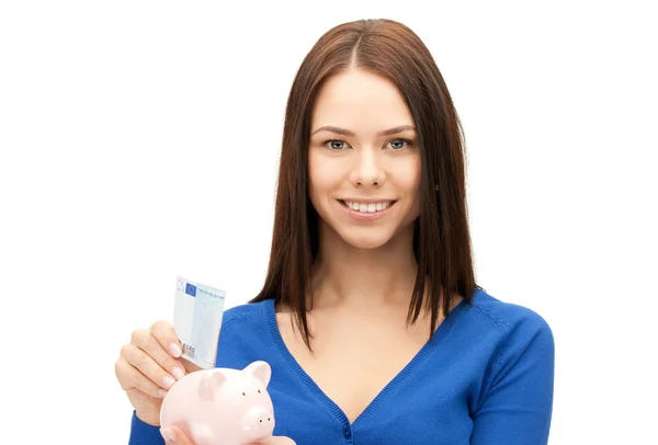 Schöne Frau mit Sparschwein und Geld — Stockfoto
