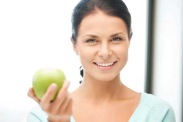 Lovely housewife with green apple Stock Picture