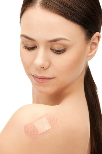Beautiful woman with plaster — Stock Photo, Image