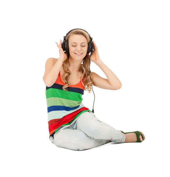 Happy teenage girl in big headphones — Stock Photo, Image