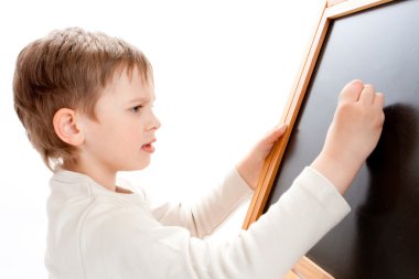 Boy writing on blackboard clipart