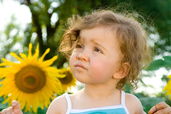 Baby with sunflower — Stock Photo, Image