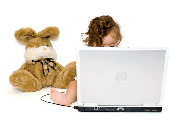 Baby girl working with laptop, isolated — Stock Photo, Image