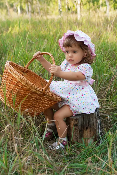 Attractive little girl holding a basket — Stock Photo, Image