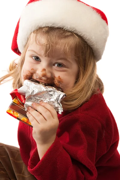 Petite gourmande au chapeau de Père Noël, isolée — Photo