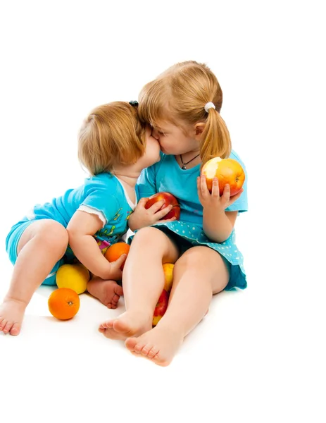 Little sisters with fruit — Stock Photo, Image