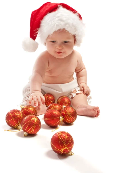 Santa şapka oynayan bebek — Stok fotoğraf