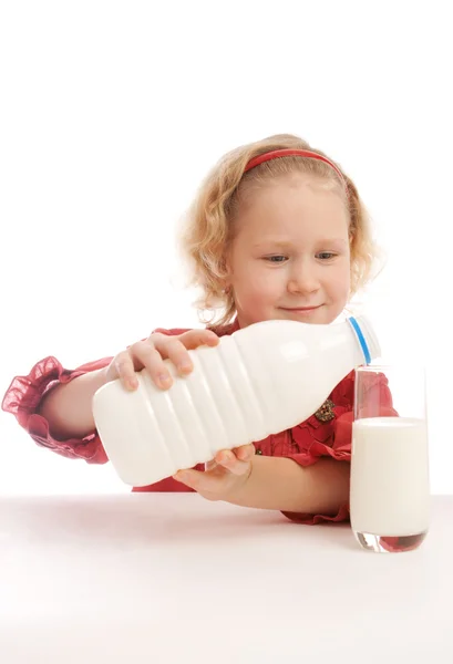 Child pouring milk — Stock Photo, Image