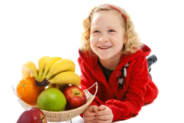 Skrattande flicka nära vas med frukt — Stockfoto