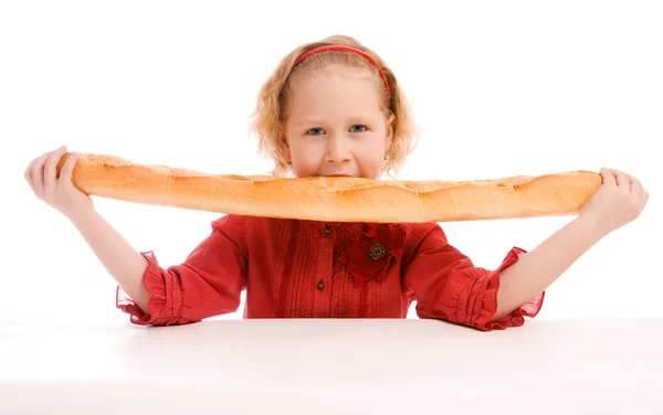 Girl eating French bread — Stock Photo, Image