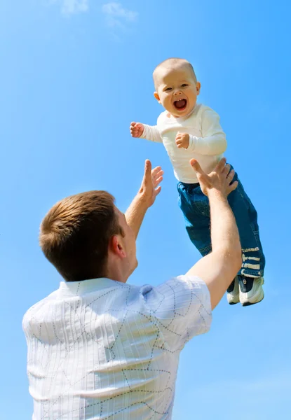 Father throwing baby — Stock Photo, Image