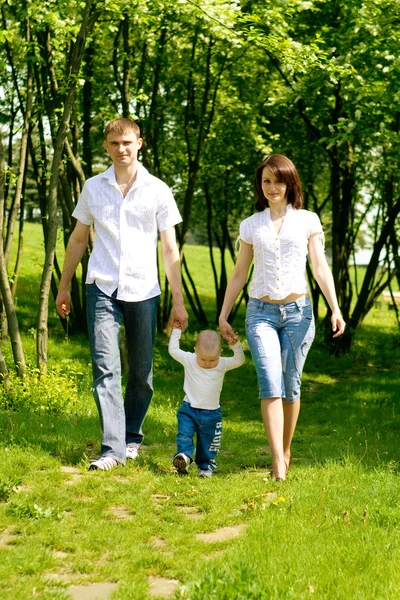 Mother, father and baby walking — Stock Photo, Image