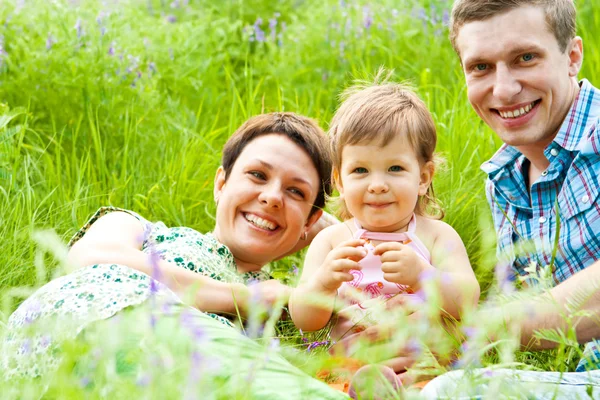Family having rest in the meadow — Stock Photo, Image
