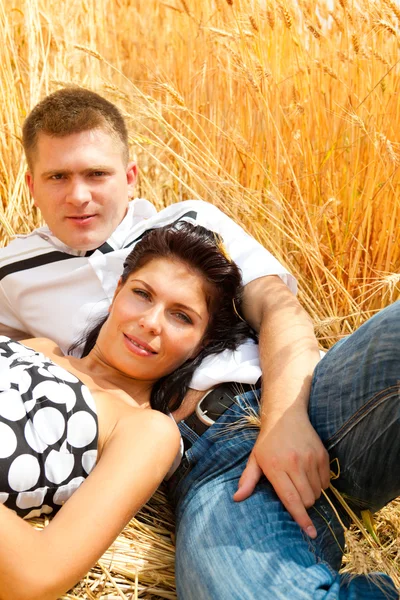 Couple having rest in wheat — Stock Photo, Image