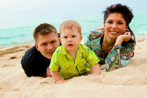Baby, mom and dad on sand — Stock Photo, Image