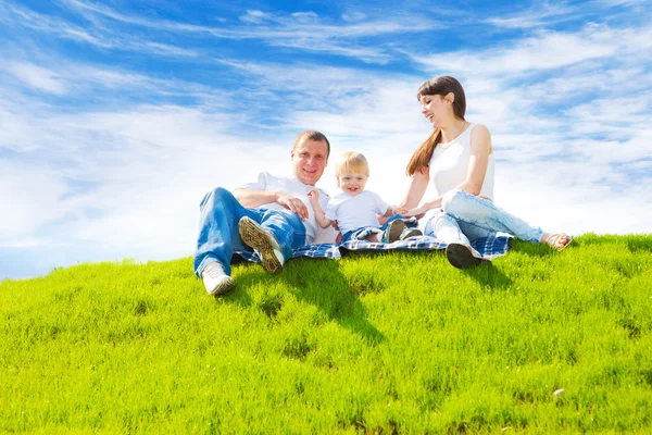 Happy family on grass — Stock Photo, Image