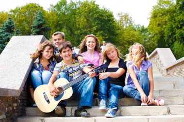 Teens playing guitar clipart