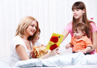 Mother reading greeting card clipart