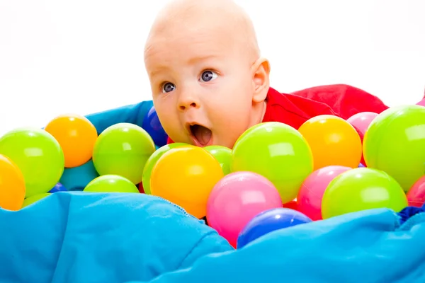 Bebê com bolas coloridas — Fotografia de Stock