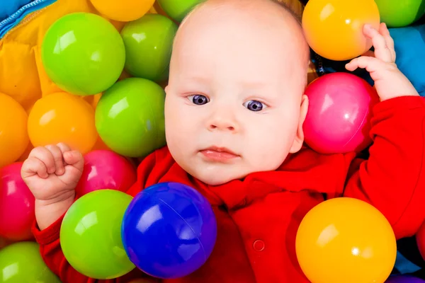 Infant with colorful balls — Stock Photo, Image