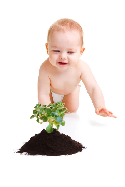 Baby mit Pflanze — Stockfoto