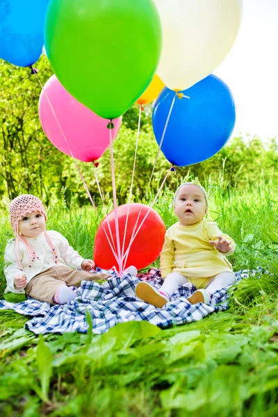 Babies with balloons — Stock Photo, Image