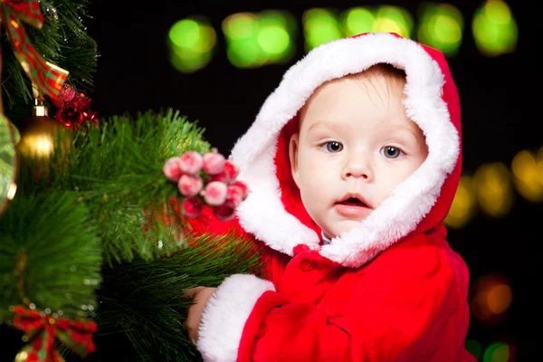 Baby decorating Christmas tree — Stock Photo, Image