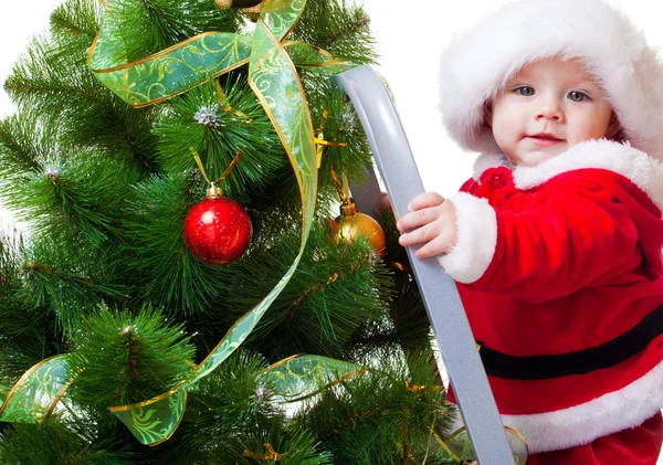 Baby in Santa costume on a step ladde — Stockfoto