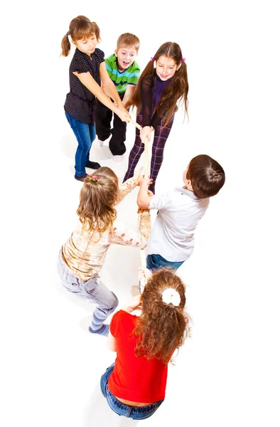 Excited kids pulling rope — Stock Photo, Image