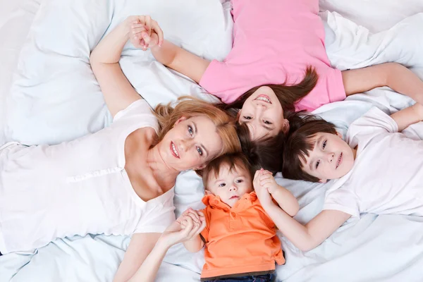 Matka a tři děti, ležící — Stock fotografie