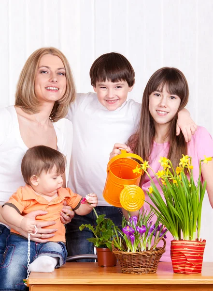 Family watering flowers — Stock Photo, Image