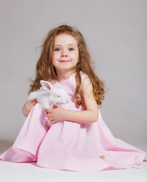 Smiling girl with white rabbit — Stock Photo, Image