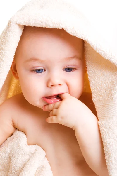 Baby med finger i munnen Stockbild