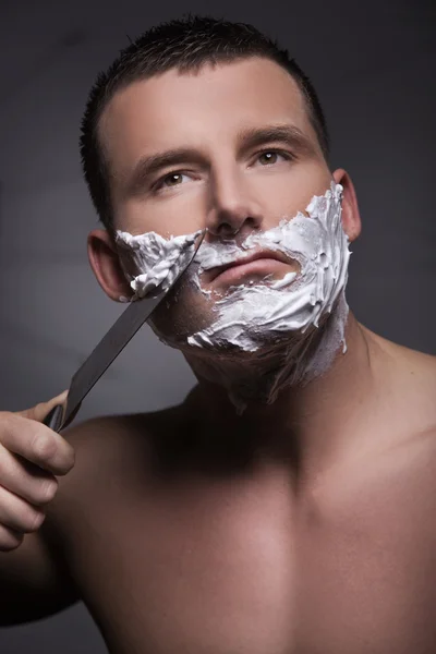 Człowiek do golenia za pomocą wielki nóż — Zdjęcie stockowe