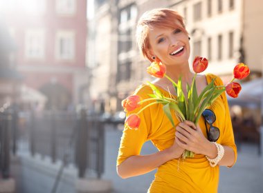 Smiling woman with bunch of flowers clipart