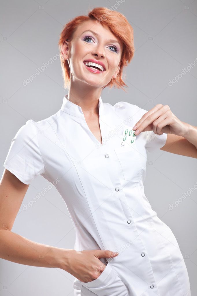 Smiling doctor showing pills