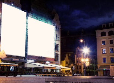 Empty white board over city night background clipart