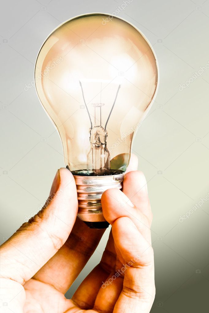Clear light Bulb shining in the hand