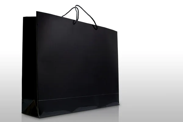 Hand en zwarte glazuur papier boodschappentas, geïsoleerd — Stockfoto
