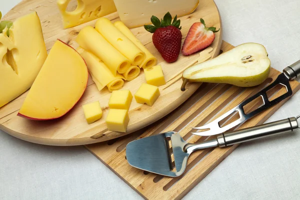 A set of cheese on a wooden board — Stock Photo, Image