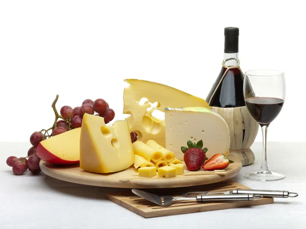 Cheese still life on a wooden round tray — Stock Photo, Image