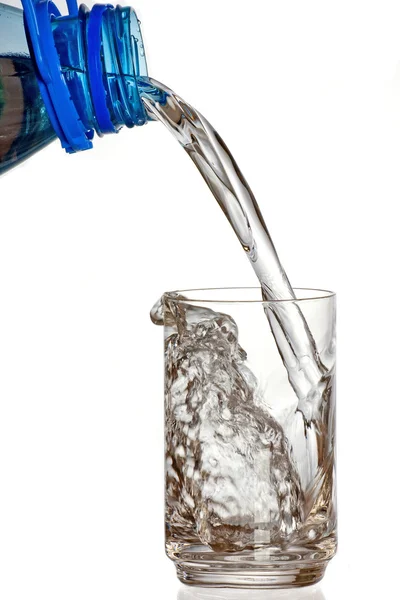 Filling a glass with water on white background — Stock Photo, Image