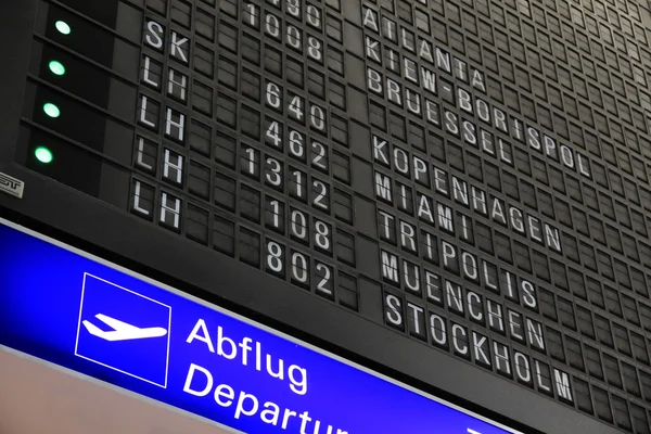 Departure board at airport — Stock Photo, Image