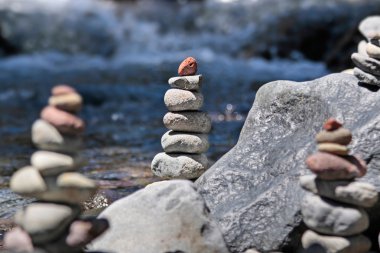 Cairn by the stream clipart