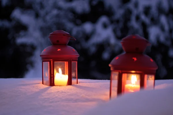 Two burning lanterns in the snow — Stock Photo, Image