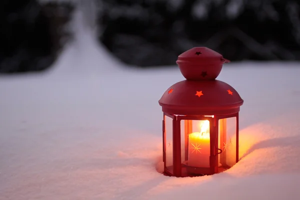 Burning lantern in the snow — Stock Photo, Image