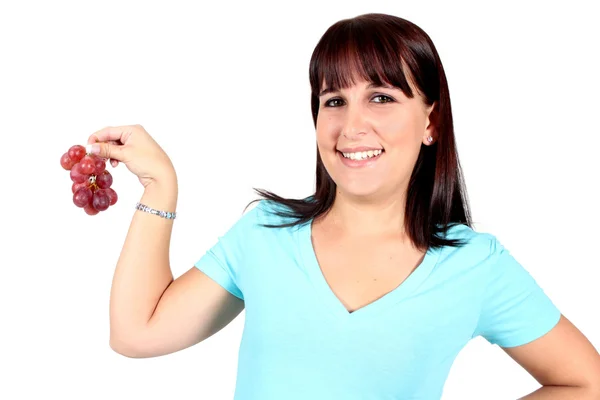 Woman holding a bunch of grapes — Stock Photo, Image